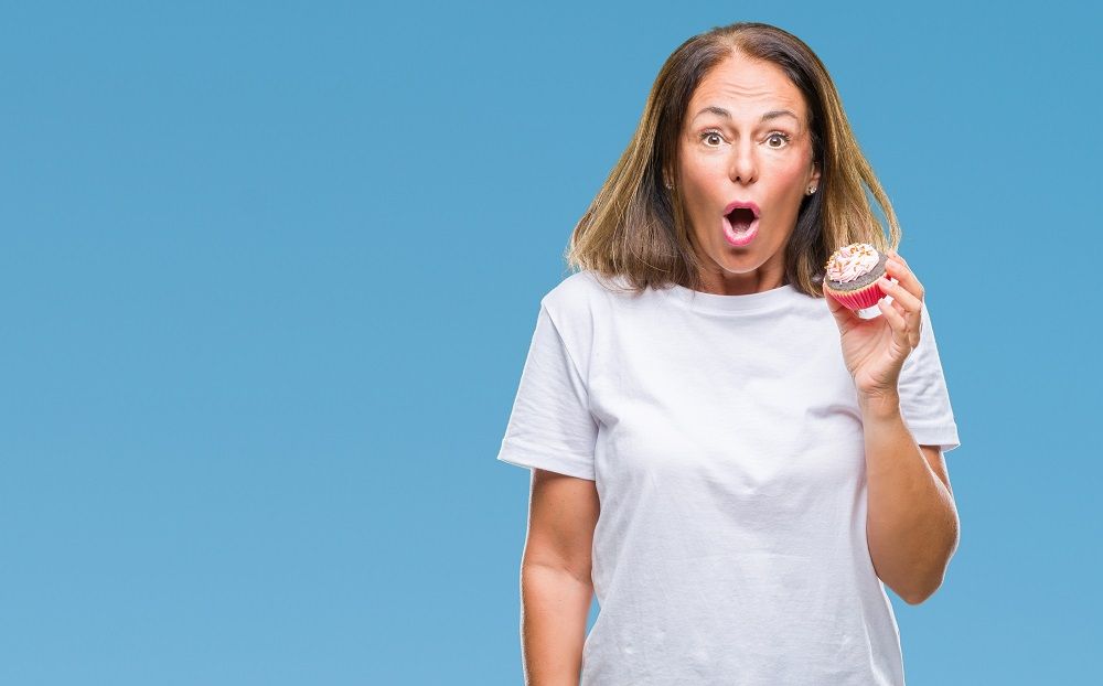 woman in shock eating cupcake sugar causes bad breath dentist in Plano Texas